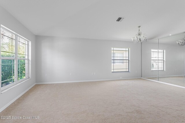 621 Misty Creek Dr, Melbourne, FL 32940 - unfurnished room with a chandelier, plenty of natural light, and light colored carpet