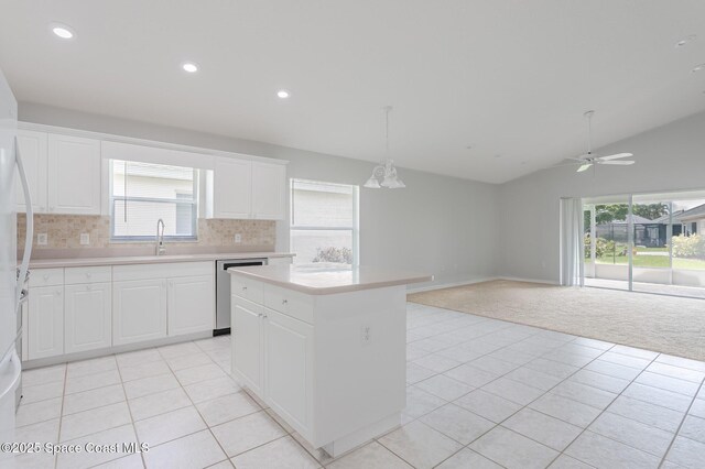 621 Misty Creek Dr, Melbourne, FL 32940 - kitchen featuring dishwasher, light carpet, light countertops, light tile patterned floors, and vaulted ceiling