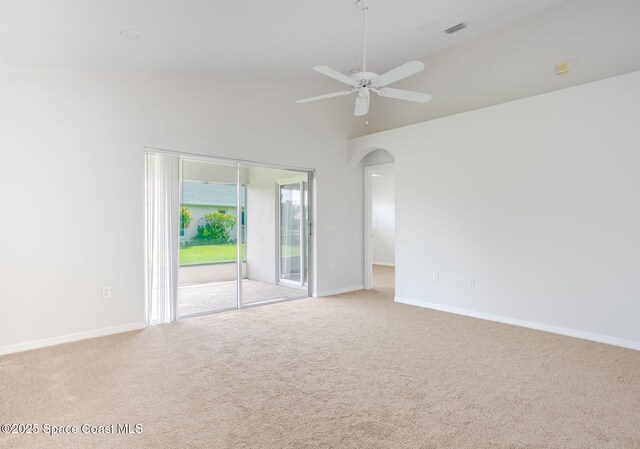 621 Misty Creek Dr, Melbourne, FL 32940 - carpeted empty room featuring arched walkways, a ceiling fan, and high vaulted ceiling