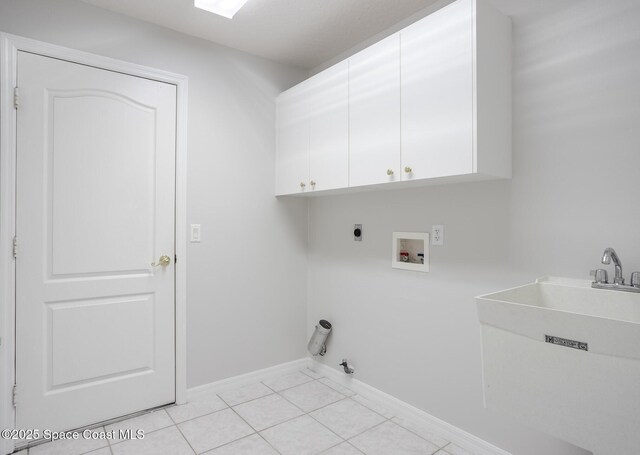 621 Misty Creek Dr, Melbourne, FL 32940 - laundry area with cabinet space, hookup for a washing machine, electric dryer hookup, light tile patterned flooring, and gas dryer hookup