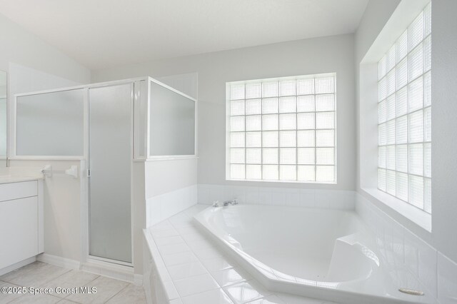 621 Misty Creek Dr, Melbourne, FL 32940 - bathroom with a stall shower, a garden tub, vanity, and tile patterned floors