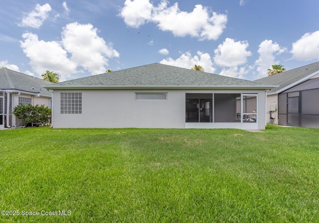 621 Misty Creek Dr, Melbourne, FL 32940 - back of house with a yard, stucco siding, and a sunroom
