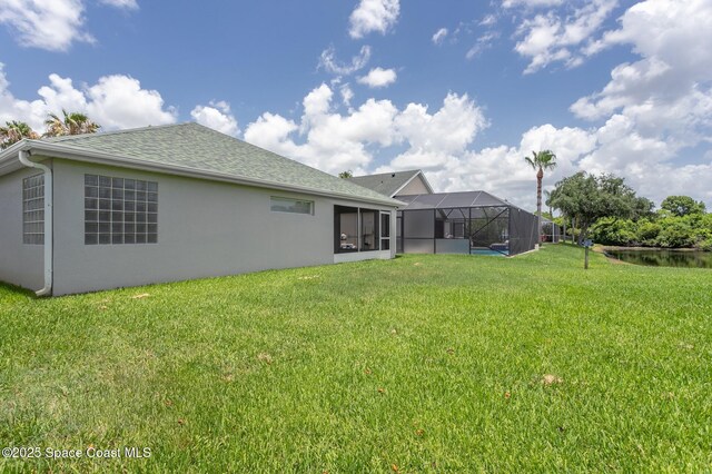 621 Misty Creek Dr, Melbourne, FL 32940 - back of house with a lawn, stucco siding, and roof with shingles