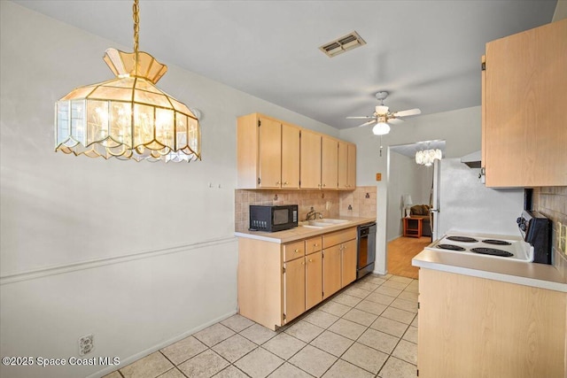 1289 Cheney Hwy Unit B, Titusville, FL 32780 - kitchen with black microwave, dishwashing machine, a ceiling fan, backsplash, and light tile patterned floors