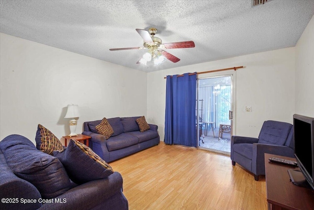 1289 Cheney Hwy Unit B, Titusville, FL 32780 - living area with wood finished floors, a ceiling fan, and a textured ceiling