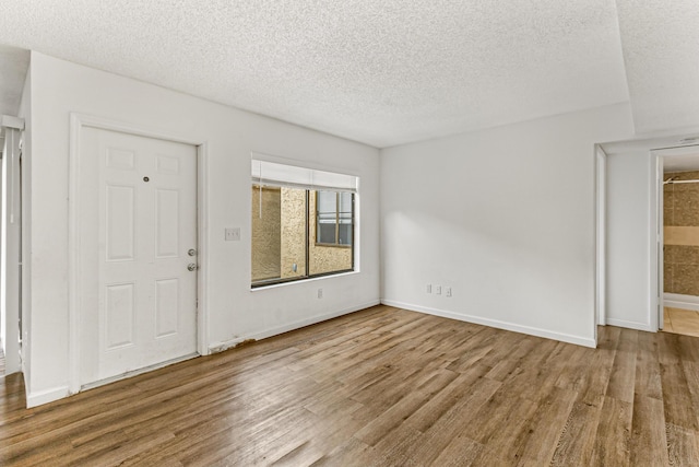 1441 Sheafe Ave NE Unit 104, Palm Bay, FL 32905 - foyer featuring wood finished floors and a textured ceiling