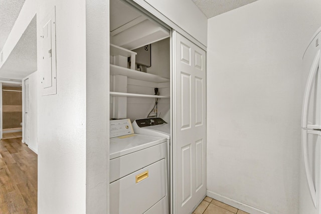 1441 Sheafe Ave NE Unit 104, Palm Bay, FL 32905 - laundry area with a textured ceiling and separate washer and dryer