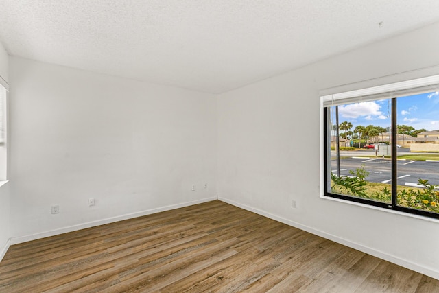 1441 Sheafe Ave NE Unit 104, Palm Bay, FL 32905 - spare room with wood finished floors and baseboards