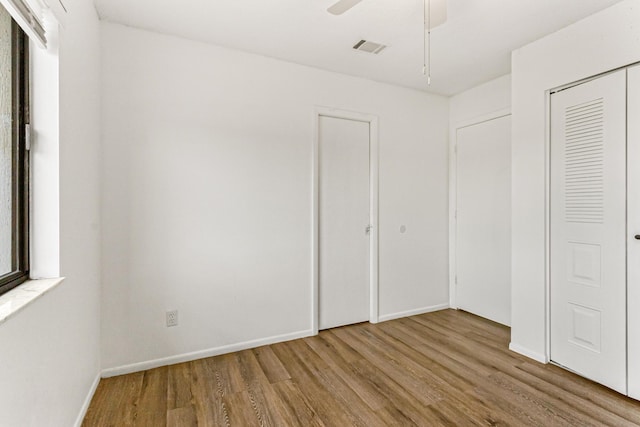 1441 Sheafe Ave NE Unit 104, Palm Bay, FL 32905 - unfurnished bedroom featuring wood finished floors and a ceiling fan
