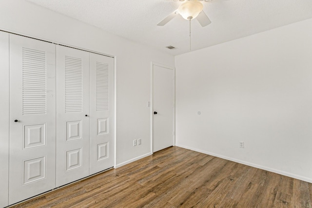 1441 Sheafe Ave NE Unit 104, Palm Bay, FL 32905 - unfurnished bedroom featuring wood finished floors, a closet, and a ceiling fan
