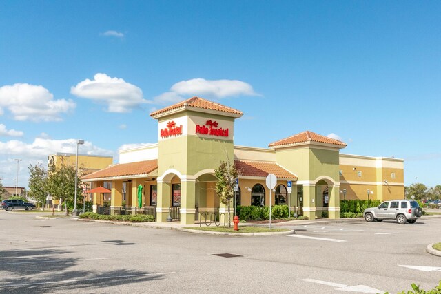 1441 Sheafe Ave NE Unit 104, Palm Bay, FL 32905 - view of building exterior featuring uncovered parking