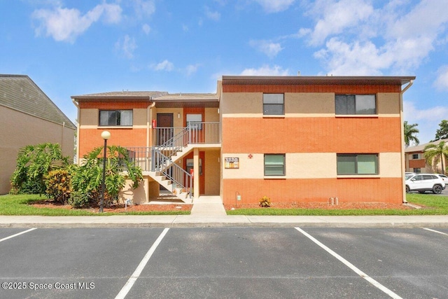 2358 Golf Lake Cir Unit 212, Melbourne, FL 32935 - view of building exterior featuring uncovered parking and stairway