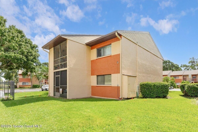 2358 Golf Lake Cir Unit 212, Melbourne, FL 32935 - view of home's exterior featuring stucco siding and a yard