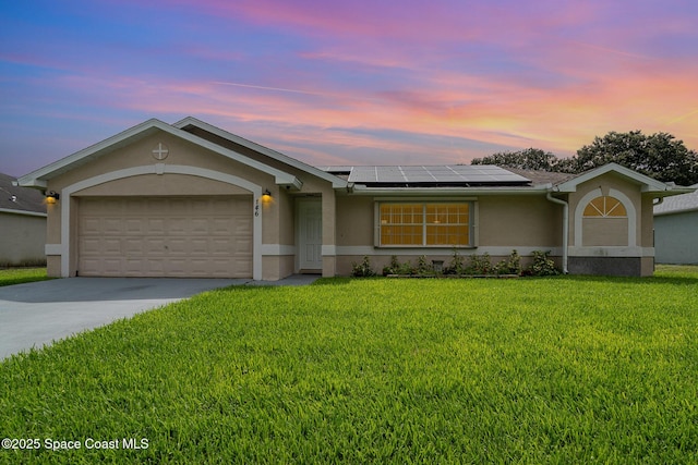 146 Oakcrest Ave NE, Palm Bay, FL 32907 - single story home featuring stucco siding, driveway, solar panels, a garage, and a lawn