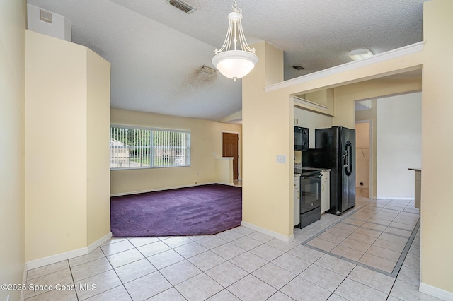 146 Oakcrest Ave NE, Palm Bay, FL 32907 - unfurnished room with light tile patterned floors, a textured ceiling, vaulted ceiling, and light carpet