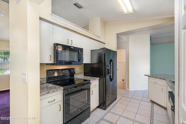 146 Oakcrest Ave NE, Palm Bay, FL 32907 - kitchen featuring black appliances, a textured ceiling, white cabinets, light tile patterned floors, and light stone countertops