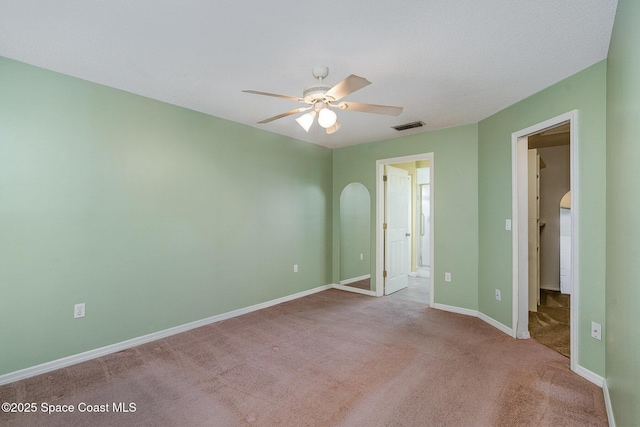 146 Oakcrest Ave NE, Palm Bay, FL 32907 - unfurnished bedroom featuring carpet flooring, ensuite bathroom, a walk in closet, and a ceiling fan