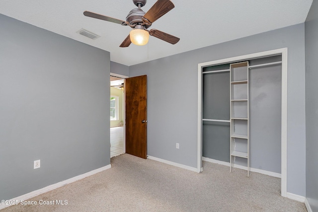 146 Oakcrest Ave NE, Palm Bay, FL 32907 - unfurnished bedroom with carpet flooring, ceiling fan, and a closet