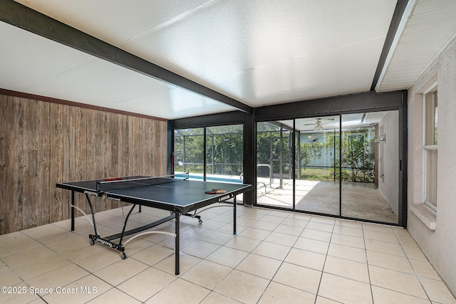 146 Oakcrest Ave NE, Palm Bay, FL 32907 - recreation room featuring wooden walls, beam ceiling, and light tile patterned floors