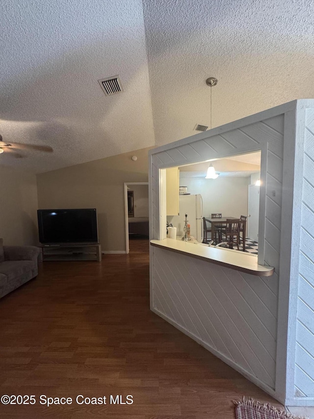 1385 Salerno Ave SE, Palm Bay, FL 32909 - kitchen with freestanding refrigerator, dark wood-style floors, a ceiling fan, open floor plan, and a textured ceiling
