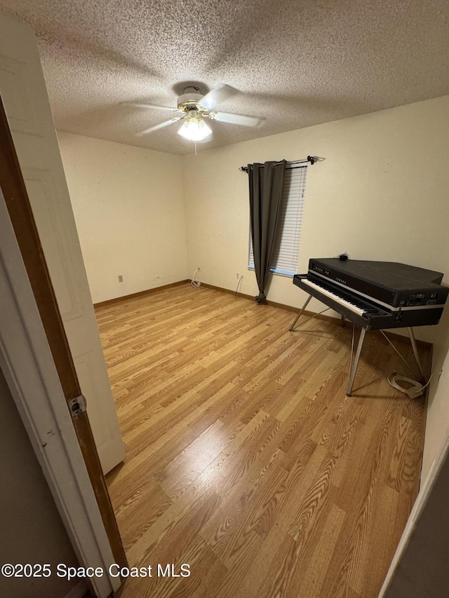 1385 Salerno Ave SE, Palm Bay, FL 32909 - sitting room featuring light wood-style floors, a ceiling fan, and a textured ceiling
