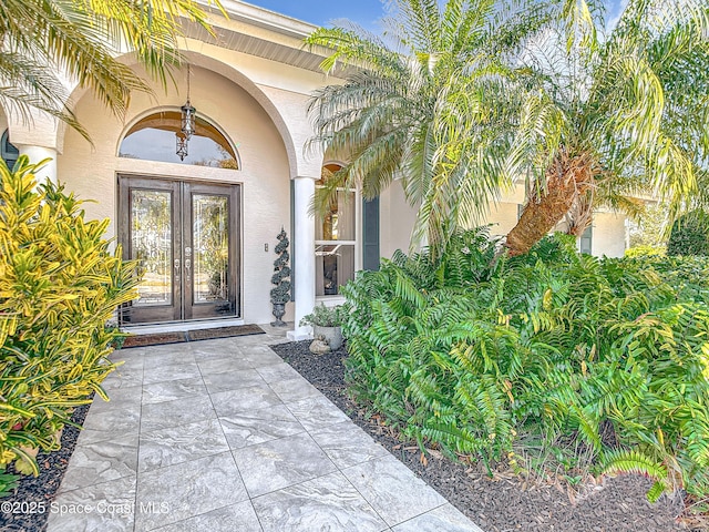 603 Cross Creek Dr, Sebastian, FL 32958 - view of exterior entry with french doors and stucco siding