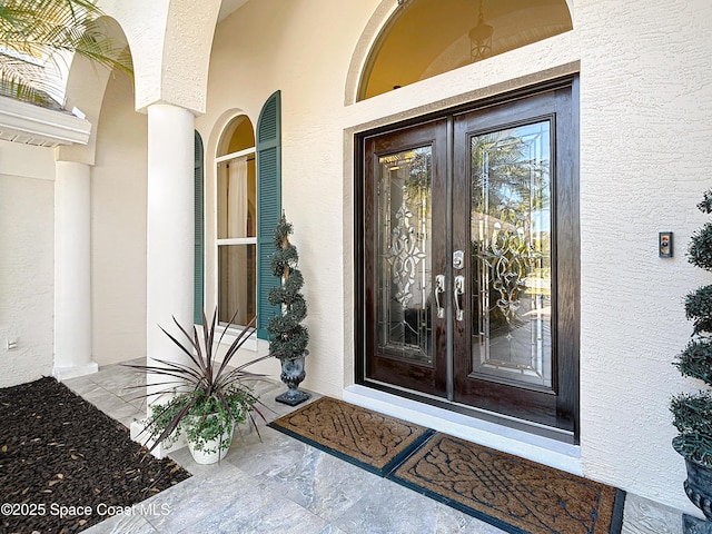 603 Cross Creek Dr, Sebastian, FL 32958 - view of exterior entry with french doors and stucco siding
