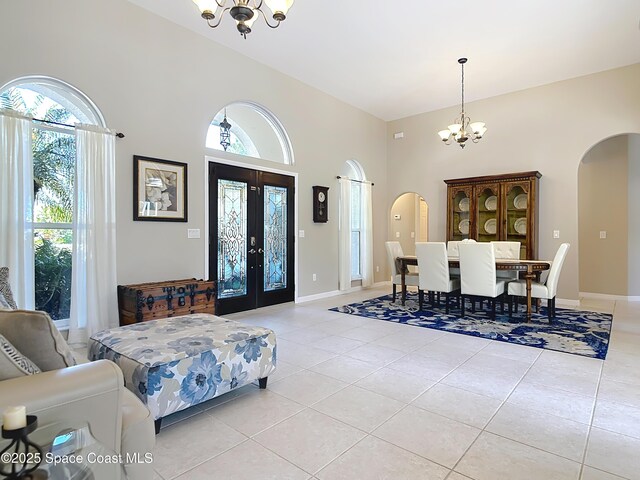 603 Cross Creek Dr, Sebastian, FL 32958 - foyer featuring a chandelier, arched walkways, light tile patterned floors, a high ceiling, and french doors