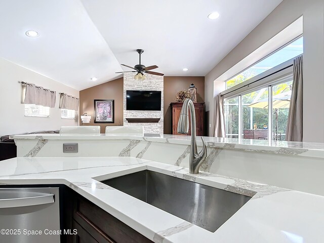 603 Cross Creek Dr, Sebastian, FL 32958 - kitchen featuring open floor plan, dishwasher, light stone countertops, a ceiling fan, and lofted ceiling