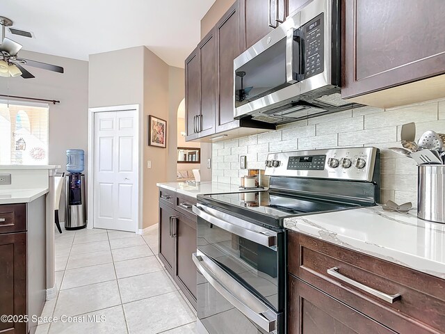 603 Cross Creek Dr, Sebastian, FL 32958 - kitchen featuring stainless steel appliances, a ceiling fan, backsplash, and dark brown cabinets