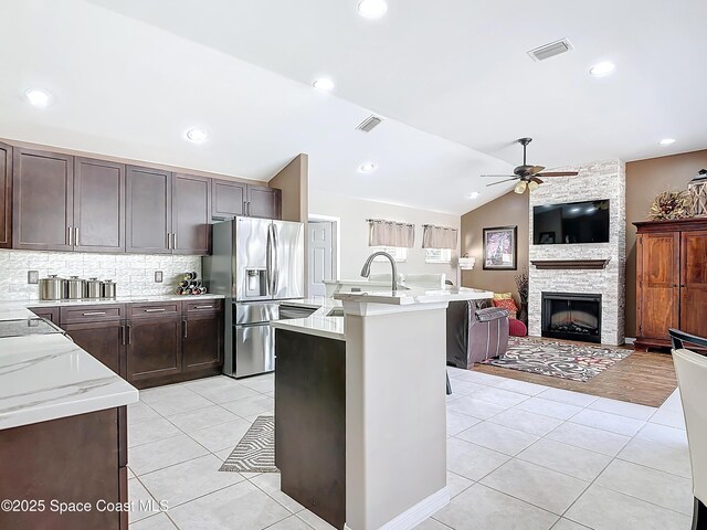 603 Cross Creek Dr, Sebastian, FL 32958 - kitchen with stainless steel fridge with ice dispenser, ceiling fan, open floor plan, backsplash, and light tile patterned floors