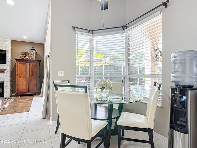603 Cross Creek Dr, Sebastian, FL 32958 - dining area with light tile patterned floors, a fireplace, and recessed lighting