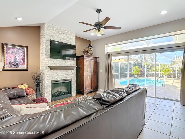 603 Cross Creek Dr, Sebastian, FL 32958 - living room with a ceiling fan, lofted ceiling, a fireplace, light tile patterned floors, and recessed lighting