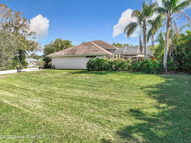 603 Cross Creek Dr, Sebastian, FL 32958 - view of green lawn with a lanai