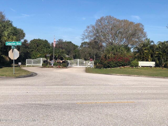 603 Cross Creek Dr, Sebastian, FL 32958 - view of asphalt street with a gate and traffic signs