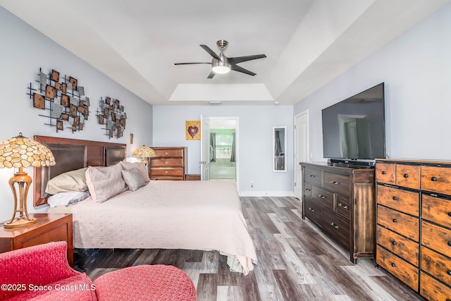 4448 Heaton Park Trl, Rockledge, FL 32955 - bedroom featuring a tray ceiling, dark wood-style floors, and a ceiling fan