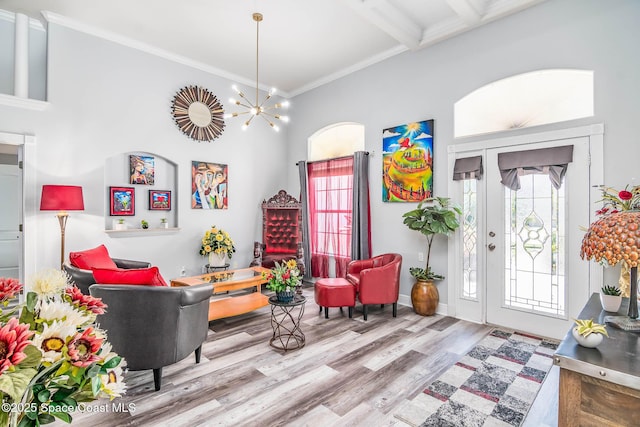 4448 Heaton Park Trl, Rockledge, FL 32955 - living area featuring wood finished floors, a high ceiling, a chandelier, and ornamental molding