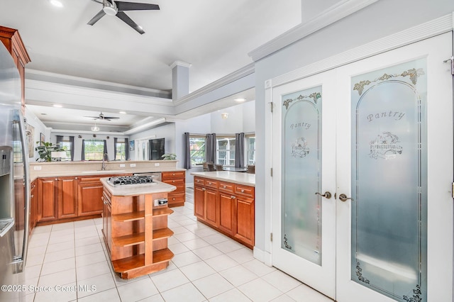 4448 Heaton Park Trl, Rockledge, FL 32955 - kitchen with a ceiling fan, light countertops, light tile patterned flooring, crown molding, and stainless steel refrigerator with ice dispenser