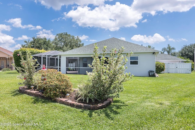 4448 Heaton Park Trl, Rockledge, FL 32955 - rear view of house with a shingled roof, stucco siding, and glass enclosure