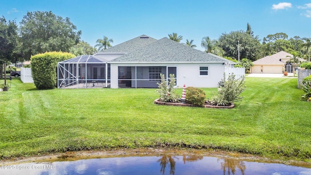 4448 Heaton Park Trl, Rockledge, FL 32955 - rear view of property featuring a shingled roof, a yard, a garage, glass enclosure, and stucco siding