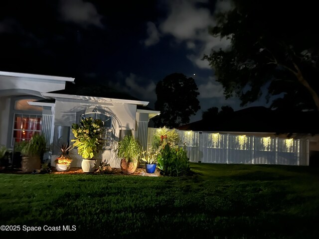 4448 Heaton Park Trl, Rockledge, FL 32955 - yard at night with a lawn