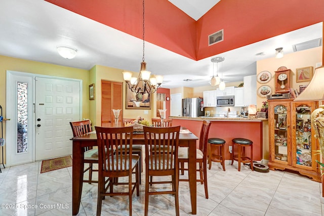 623 Manatee Dr, Satellite Beach, FL 32937 - dining area with a chandelier and light marble finish flooring