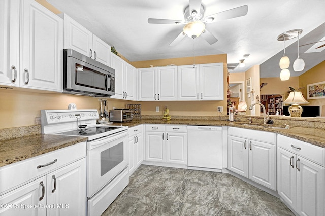 623 Manatee Dr, Satellite Beach, FL 32937 - kitchen featuring white appliances, white cabinets, a ceiling fan, stone countertops, and pendant lighting