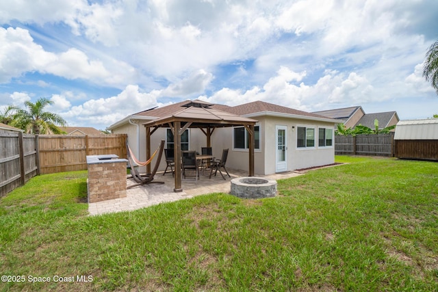 967 Sabal Grove Dr, Rockledge, FL 32955 - rear view of property featuring a fire pit, a gazebo, a patio area, and a fenced backyard