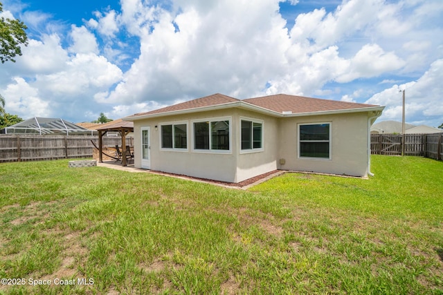 967 Sabal Grove Dr, Rockledge, FL 32955 - back of property with a gazebo, stucco siding, a fenced backyard, and a patio area