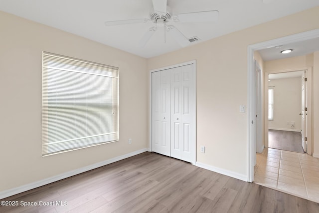 967 Sabal Grove Dr, Rockledge, FL 32955 - unfurnished bedroom featuring multiple windows, light wood-style flooring, a closet, and ceiling fan