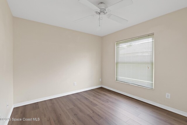967 Sabal Grove Dr, Rockledge, FL 32955 - unfurnished room with dark wood-type flooring and a ceiling fan