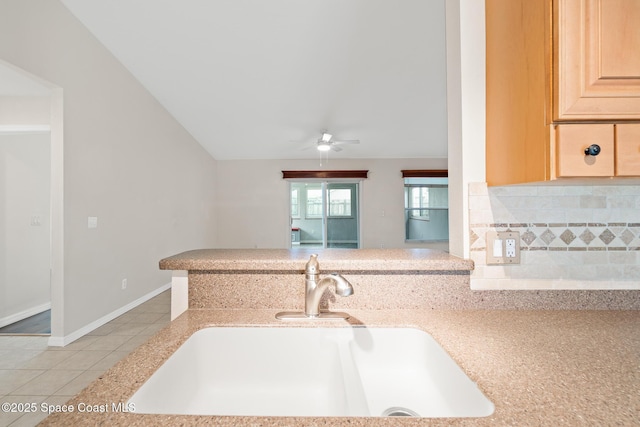 967 Sabal Grove Dr, Rockledge, FL 32955 - kitchen with light tile patterned floors, a ceiling fan, light brown cabinets, tasteful backsplash, and vaulted ceiling