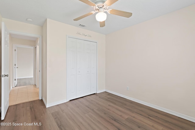 967 Sabal Grove Dr, Rockledge, FL 32955 - unfurnished bedroom featuring wood finished floors, a closet, and ceiling fan
