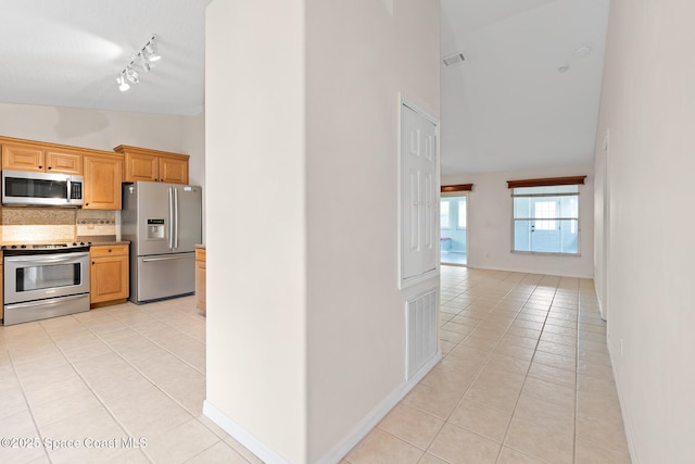 967 Sabal Grove Dr, Rockledge, FL 32955 - kitchen featuring appliances with stainless steel finishes, light tile patterned floors, backsplash, high vaulted ceiling, and track lighting